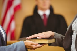 Witness swearing on the bible telling the truth in the court room-1